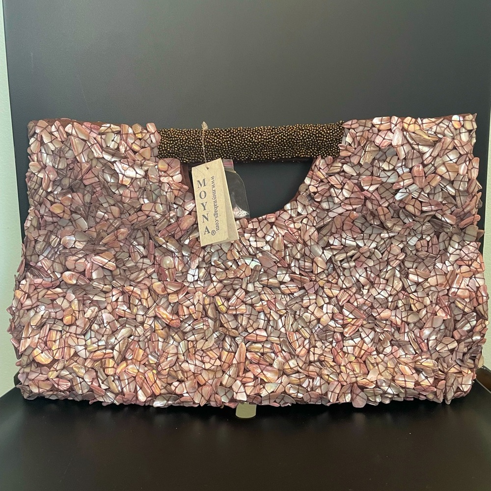 Handcrafted shell embroidered handbag.